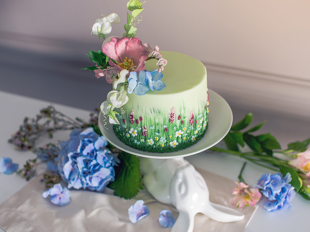 Wedding spring cake decorated with beautiful flowers and hydrangeas. Desserts for a festive summer mood