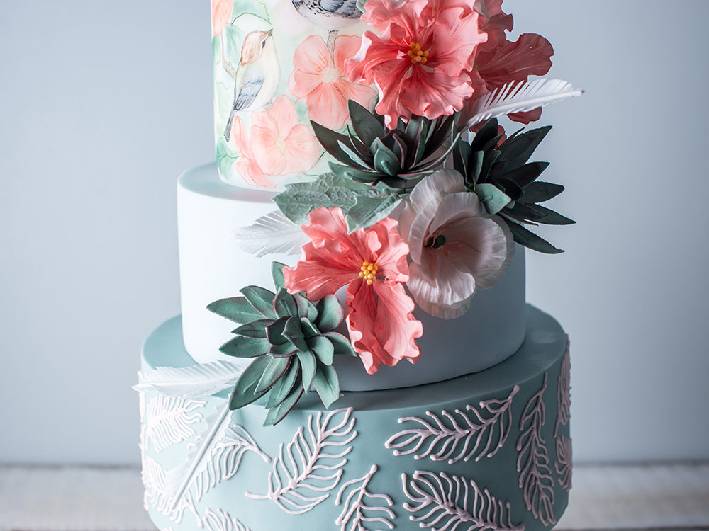 Beautiful home wedding four-tiered cake decorated with spring red flowers and handmade pattern. The concept of delicious desserts